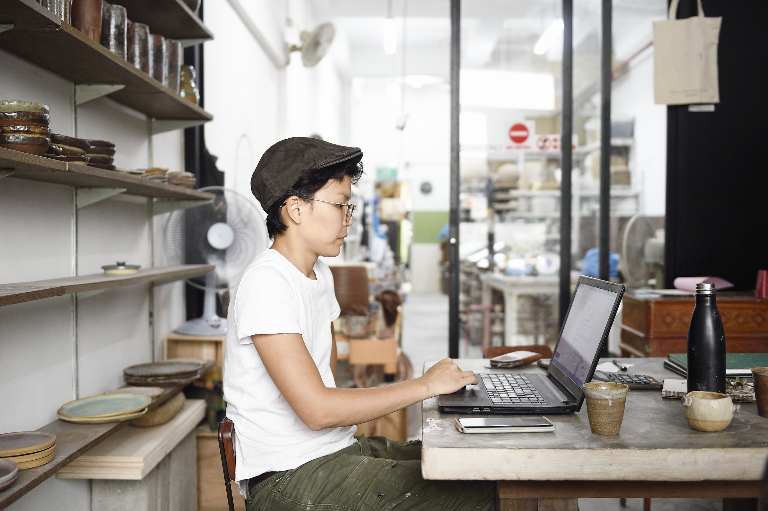Woman using laptop in retail setting